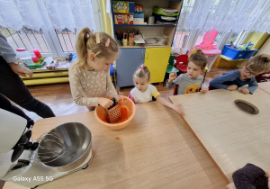 dziewczynka ściera marchewkę na tarce