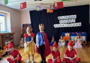 Królewna Śnieżka z królewiczem i krasnoludkami.