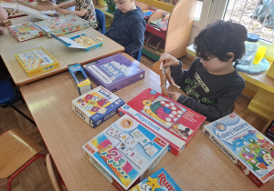 dzieci przy stolikach grają w różne matematyczne gry