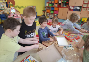 dzieci przy stolikach grają w różne matematyczne gry