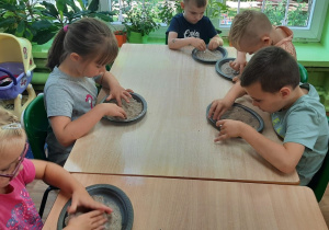 Dzieci bawią się piaskiem.