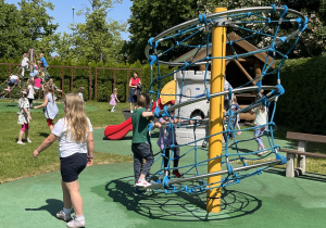 Dzieci bawią się na przedszkolnym placu zabaw.