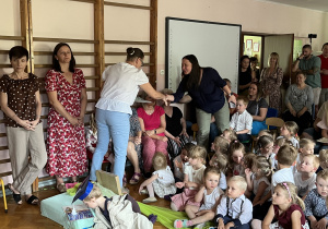 Nauczycielki wręczają podziękowania rodzicom.