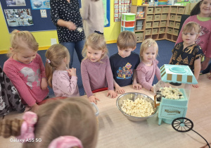 dzieci robią popcorn w specjalnej maszynie do popcornu