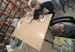 dzieci podczas zajęć rozwijających zainteresowania czytelnicze w bibliotece