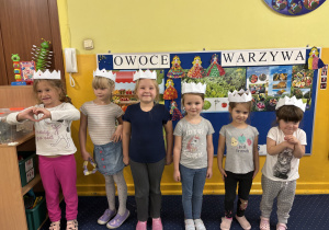 Dziewczynki prezentują swoje korony z origami.