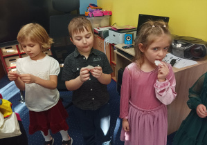 dzieci składają sobie życzenia, dzielą się opłatkiem