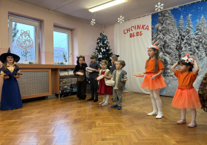 Dzieci grają na instrumentach i śpiewają piosenkę.