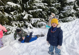 dzieci bawią się na śniegu