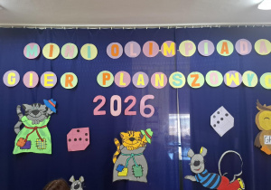 napis na niebieskim kotarze Mini Olimpiada Gier Planszowych
