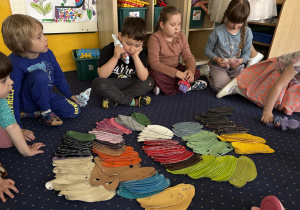 Dzieci wybierają ubranka dla swoich zajączków.