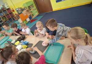 dzieci przygotowują podwieczorek z różnych produktów