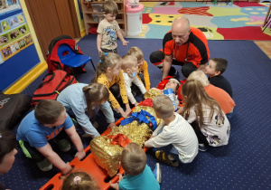 ratownik medyczny z wizytą u dzieci z grupy 2, dzieci poznają zawód ratownika medycznego, uczą się pierwszej pomocy